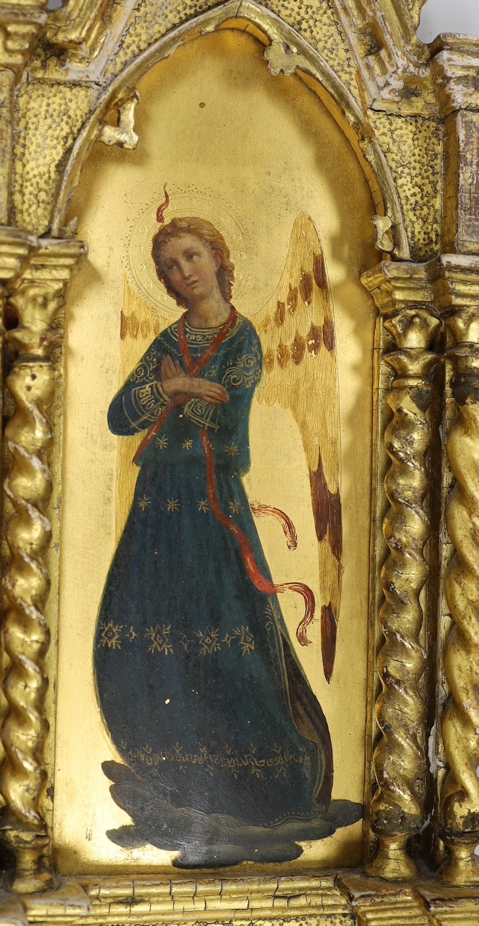 Manner of Fra Angelico, late 19th century, a pair of oils and gilt on panel, Archangels, mounted in ornate carved gilt wood frames (one a.f), 54 x 18cm total